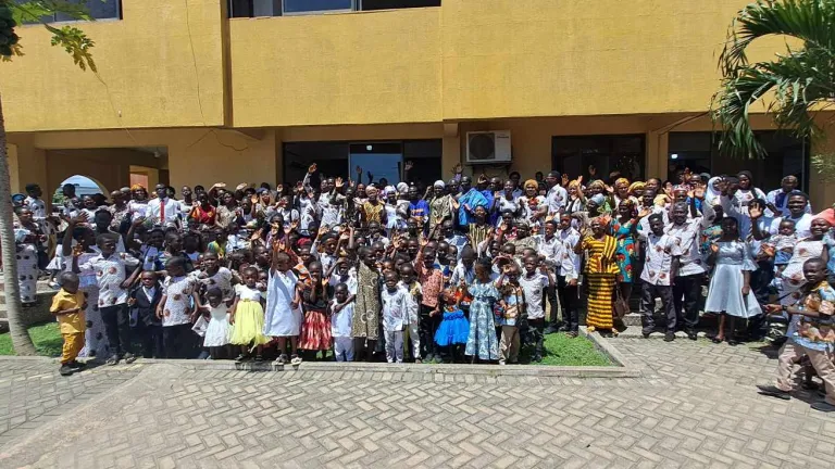 2024 Feast of Tabernacles Cape Coast, Ghana a large group of people gathered in front of a yellow building